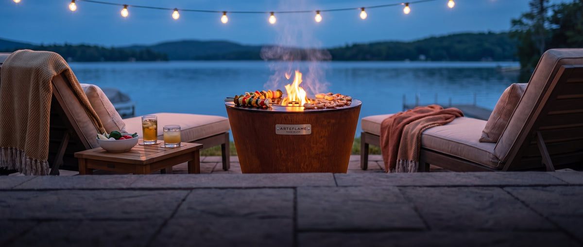 Arteflame ONE20 on a lakeside deck at dusk