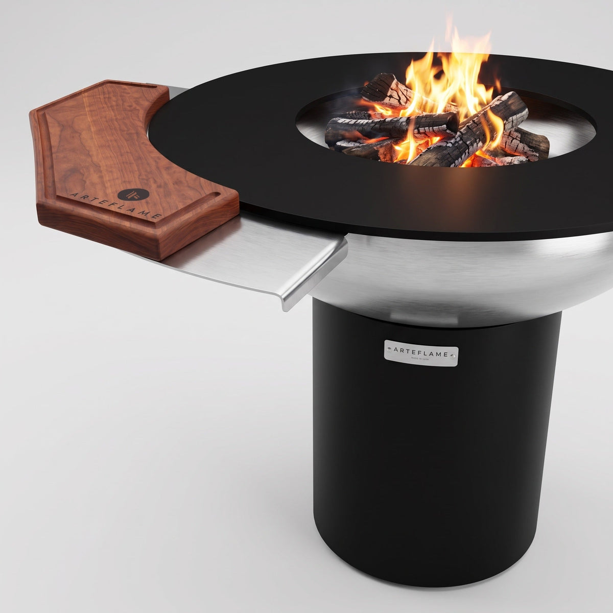 Side warming table and wood cutting board on an Arteflame cooktop